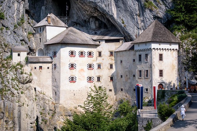 Postojna Cave & Photostop Predjama castle - Group Tour from Koper - Predjama Castle from the roadside viewpoint